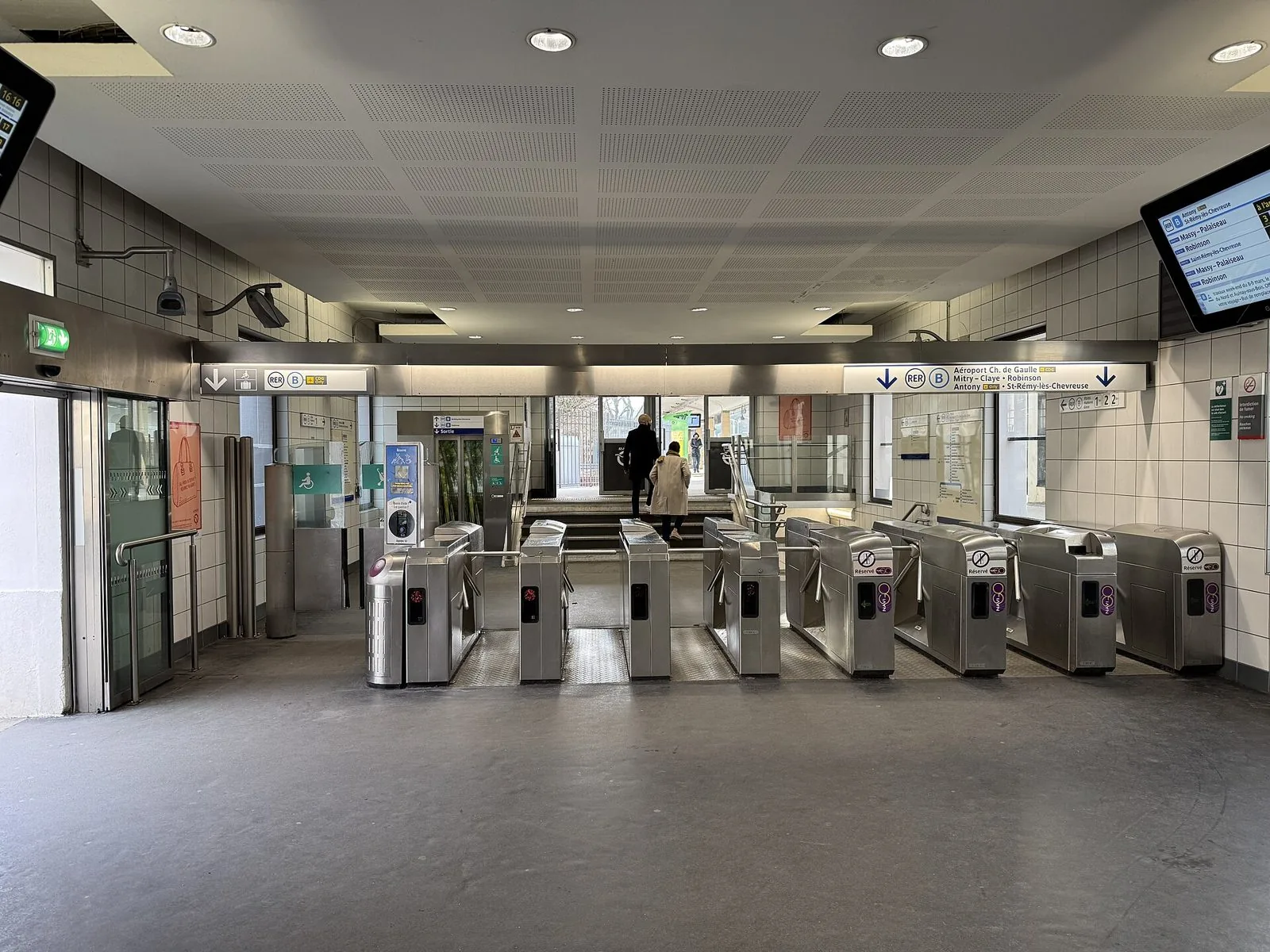 Tornelli e cartelli della RER B nell'atrio della stazione di Bourg-la-Reine